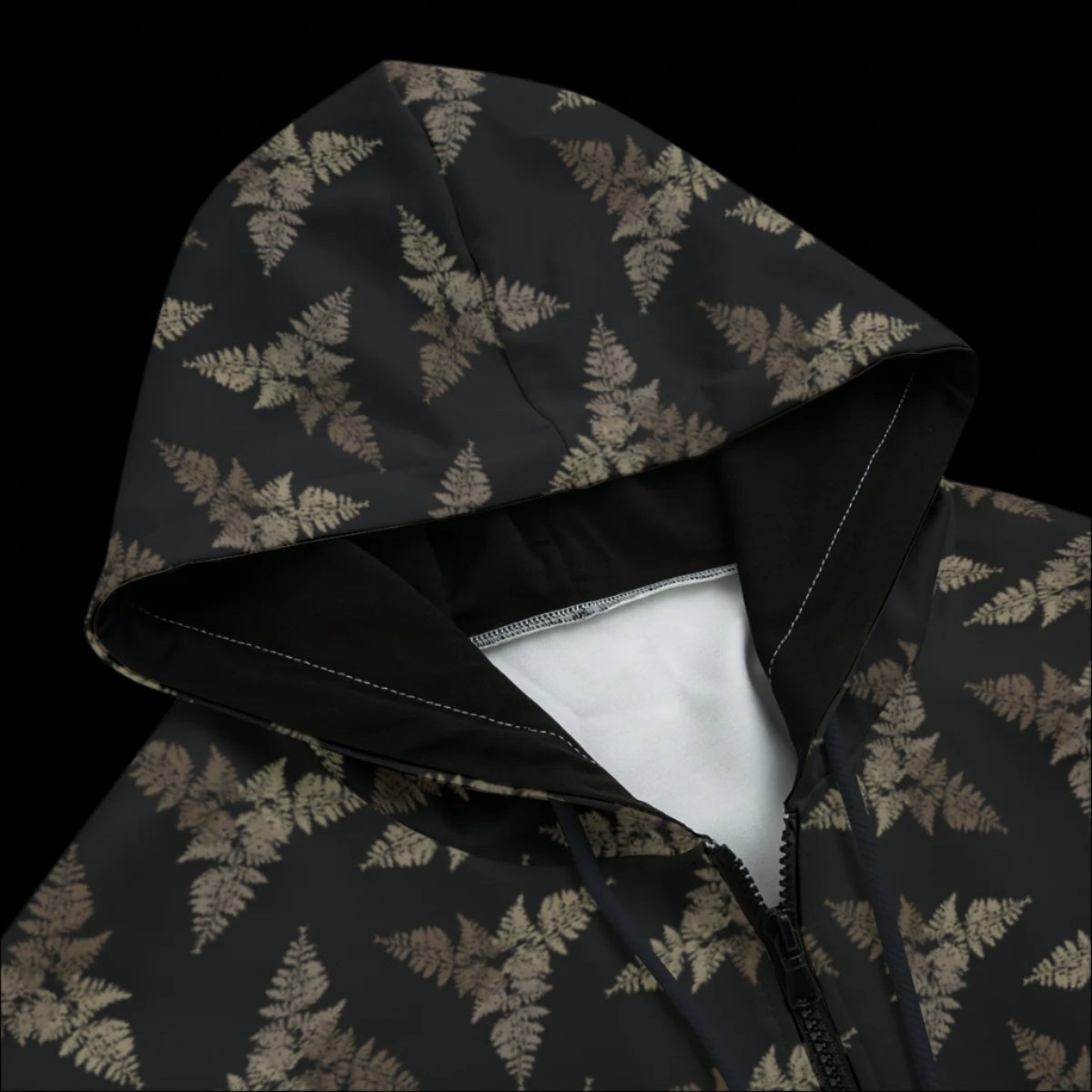 Top front of a hoodie with a dark subtle leaf pattern and a black background