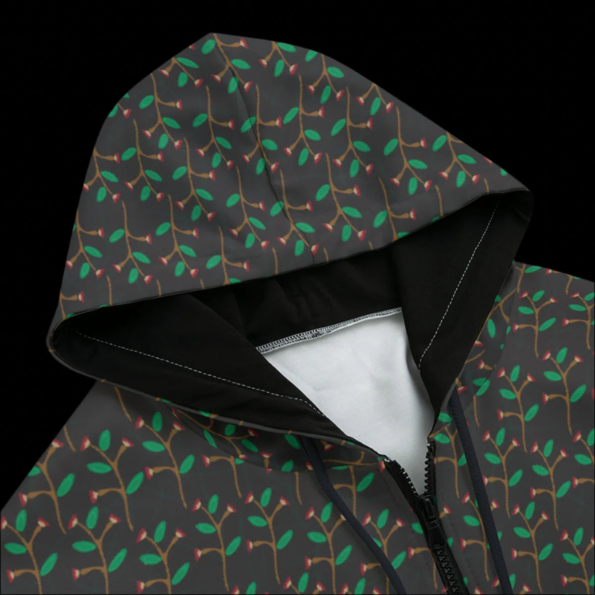 Front top of hoodie with a dark leaf pattern on a black background