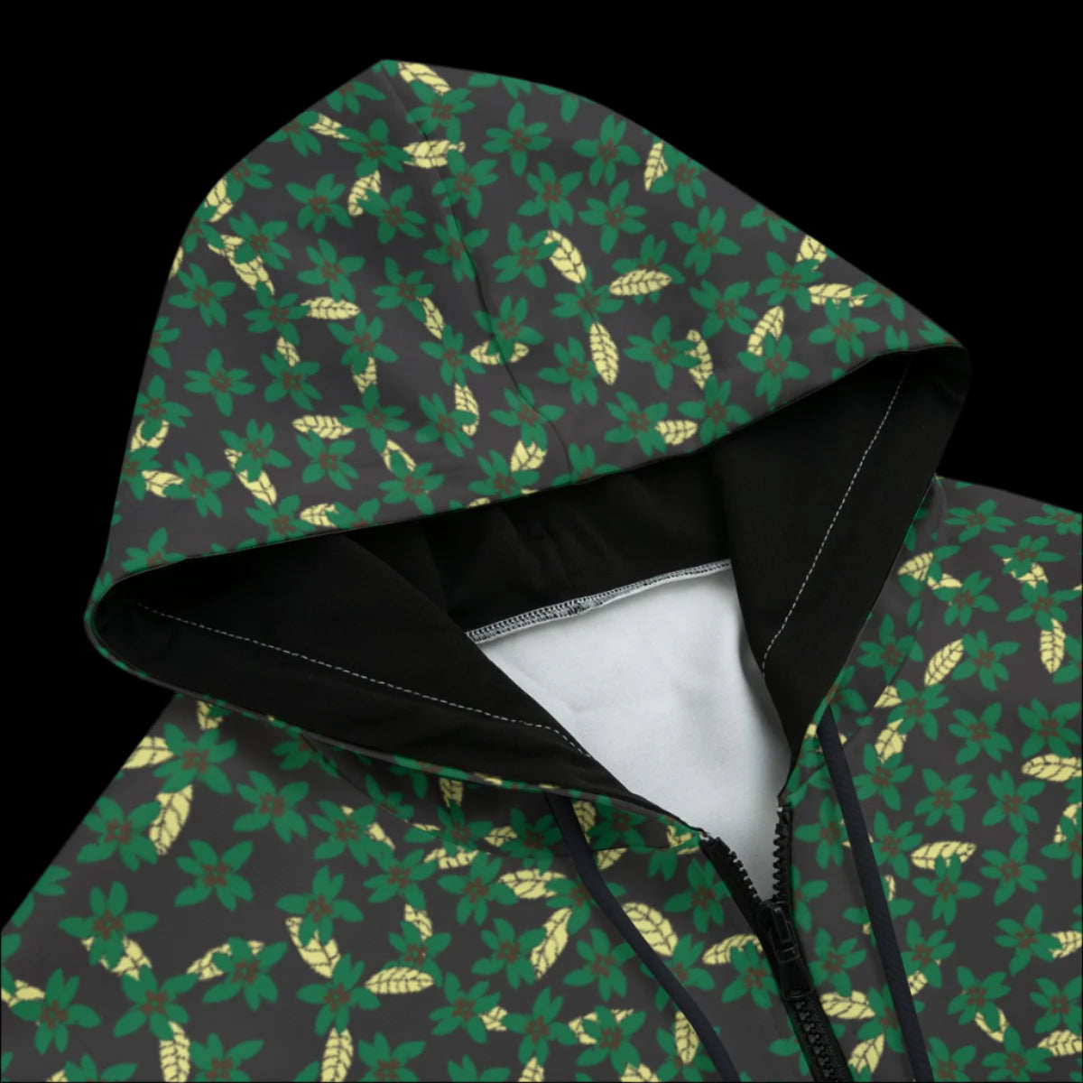 Front top of green hoodie with leaf pattern on a black background