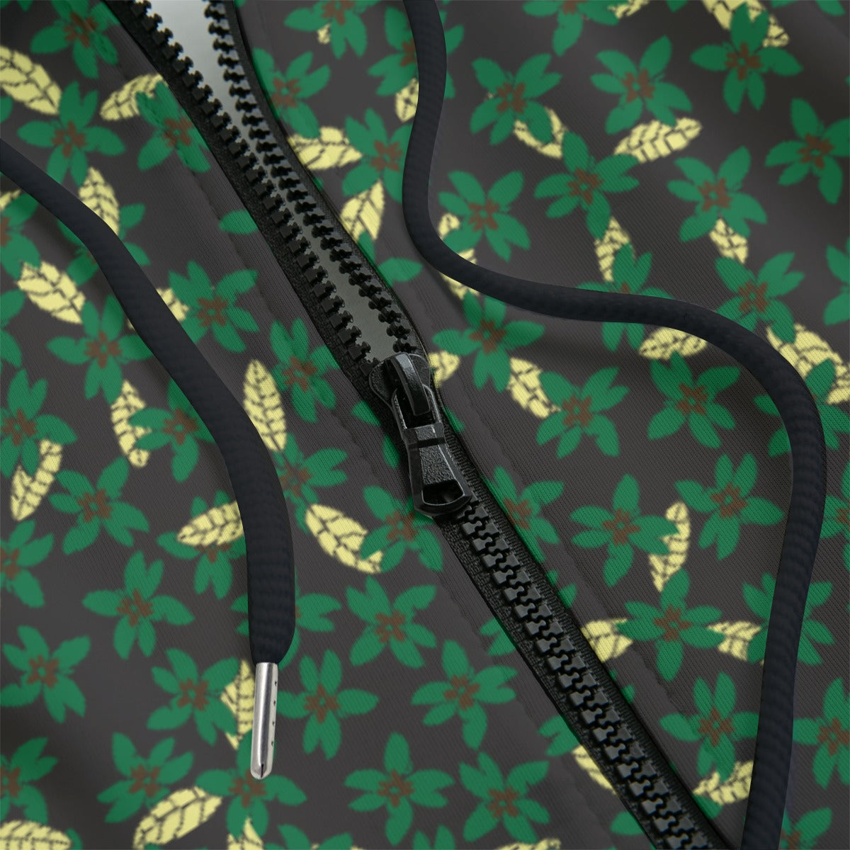 Front detail of green hoodie with leaf pattern on a black background