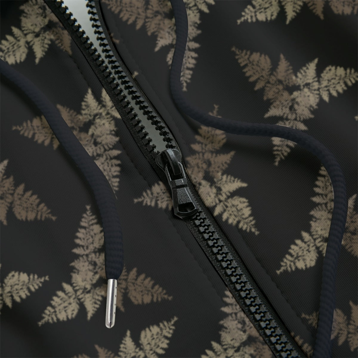 Close-up of a hoodie with a dark subtle leaf pattern