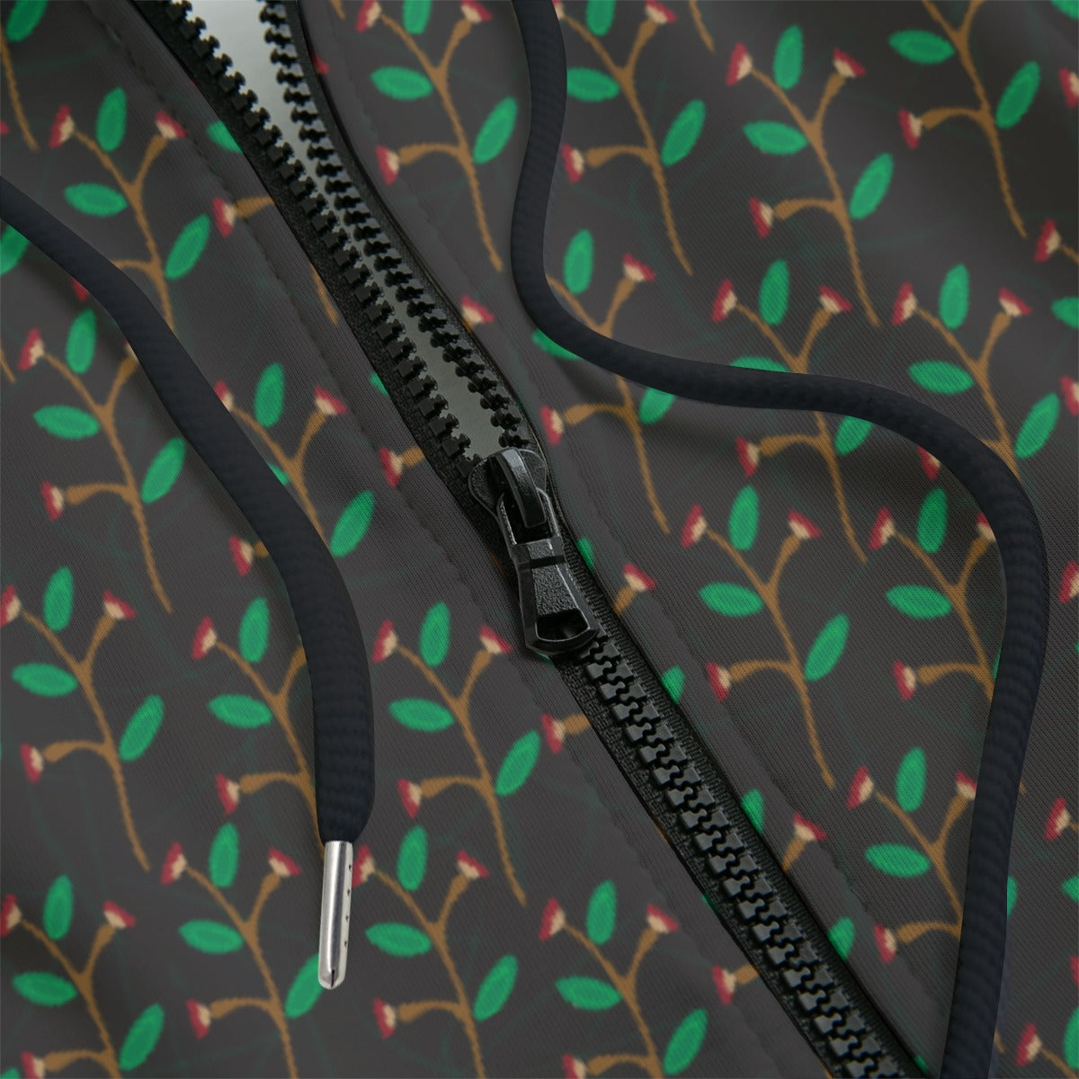 Front detail of hoodie with a dark leaf pattern on a black background