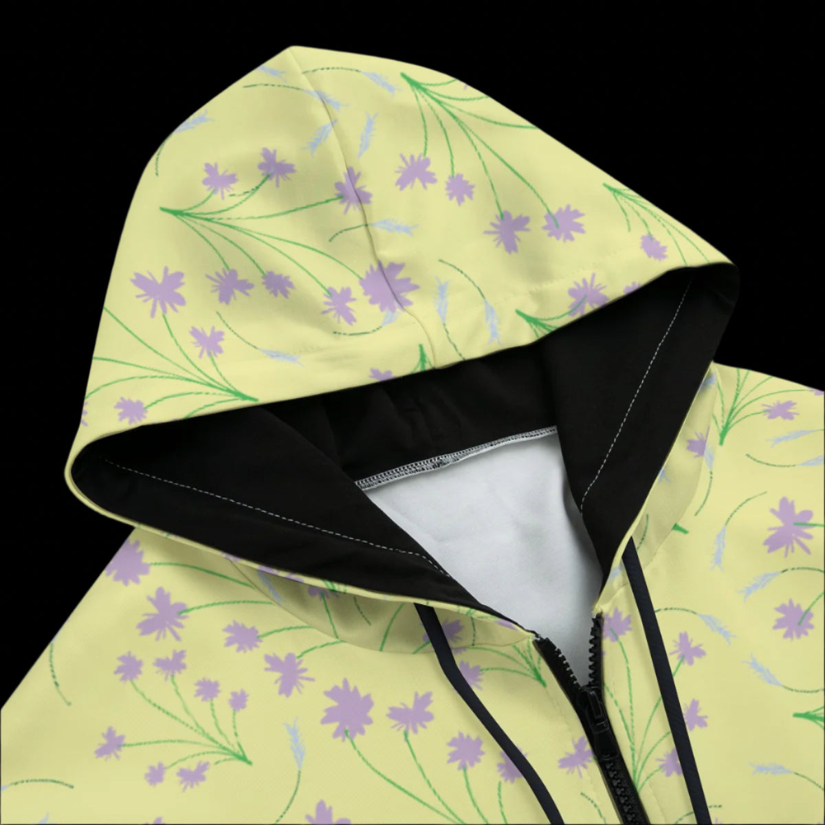 Front top of yellow hoodie with floral pattern on a black background