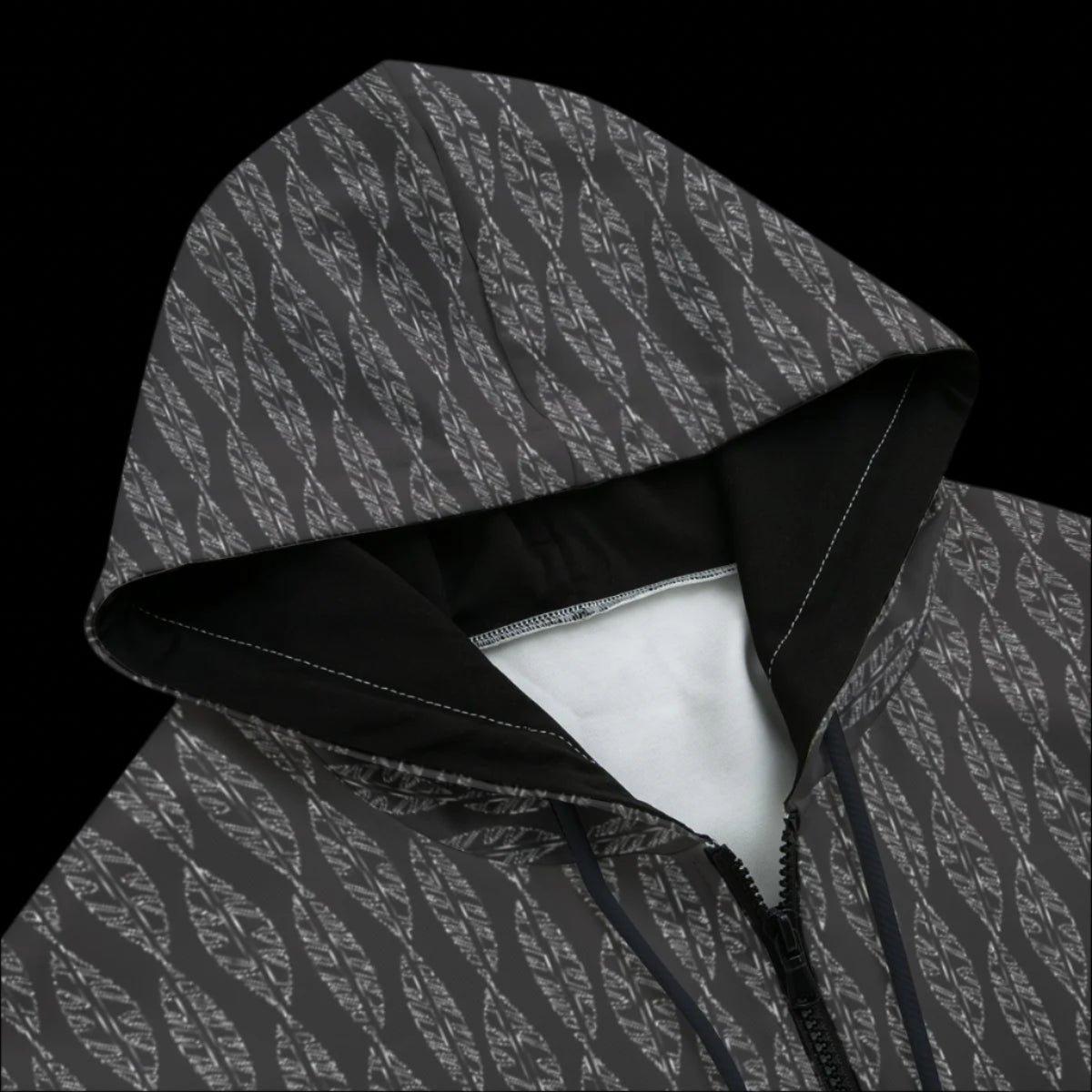 Front top of black patterned hoodie on a black background