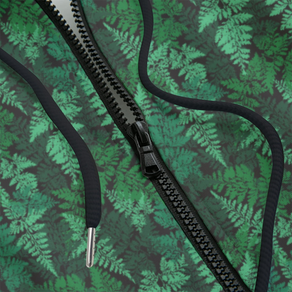Front detail of a green leafy patterned zipper hoodie