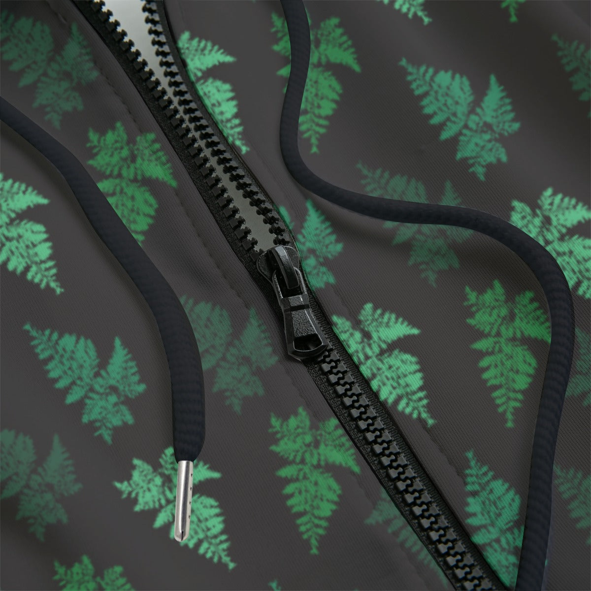 front detail of Hoodie with green leaf pattern on a black background