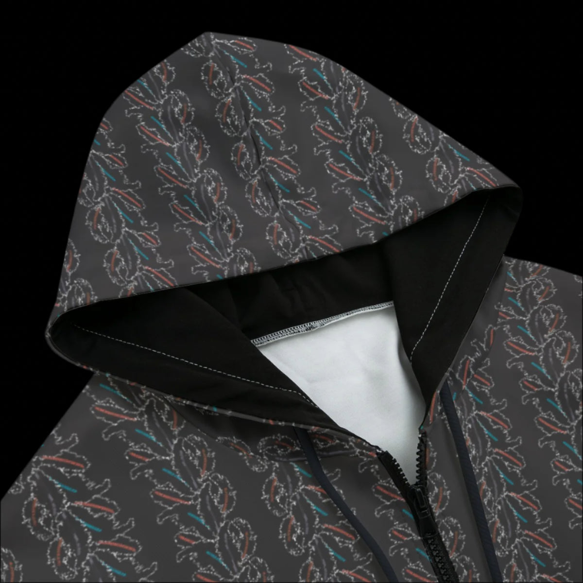 Front top of a dark patterned zipper hoodie on a black background