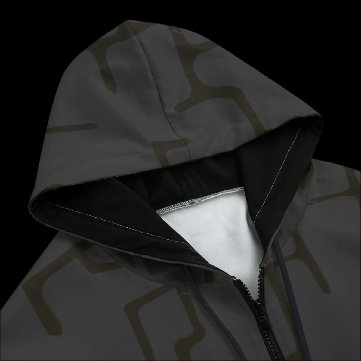 Front of dark patterned hoodie with a black background