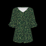 Front of green patterned blouse on a black background