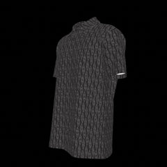 Left side of a black patterned button down short sleeve shirt on a black background