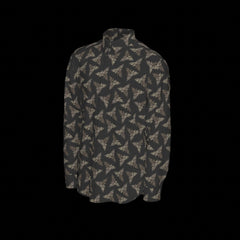 Left side of a patterned long sleeve shirt on a black background