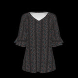 Front of black patterned blouse on a black background