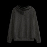 Back of a black patterned hoodie on a black background