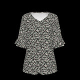 Front of floral patterned blouse on a black background