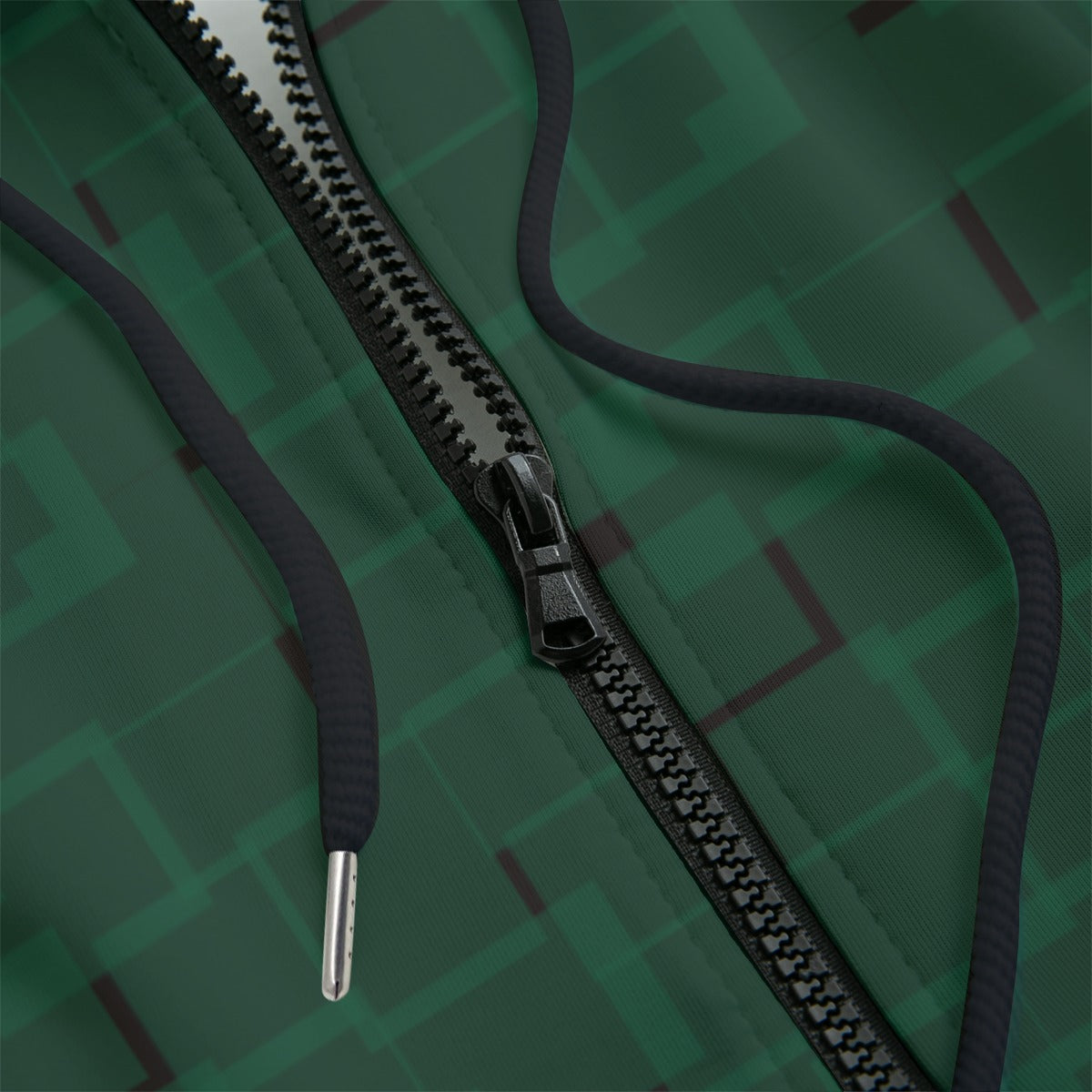 Front detail of green patterned hoodie on a black background