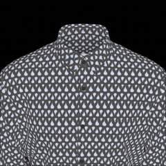 Top front of a patterned shirt with small white shapes on a black background