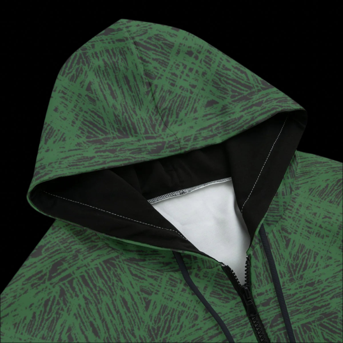 Front top of a green patterned hoodie on a black background
