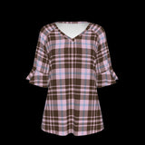 Front of plaid patterned blouse with ruffled sleeves on a black background