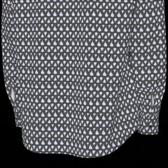 Bottom back of a patterned shirt with small white shapes on a black background