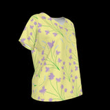 Right side of yellow V-Neck t-shirt with purple floral pattern on a black background