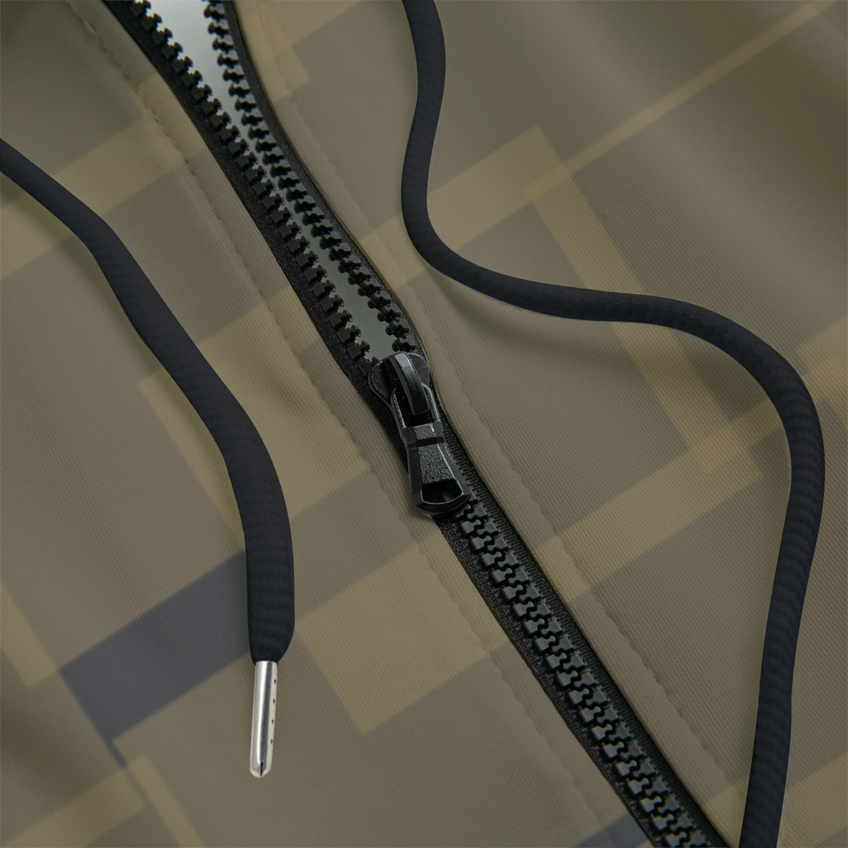 Close-up detail of a hoodie with a black zipper and hood ties
