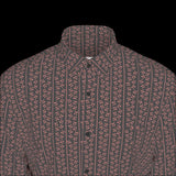 Top front of a long sleeved patterned shirt on a black background