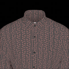 Top front of a long sleeved patterned shirt on a black background