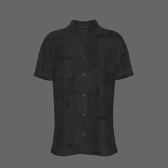 Front of a black textured short-sleeve button-down shirt on a black background