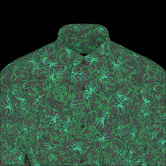 Top front of a green patterned long sleeve shirt on a black background