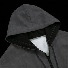 Top front of a black and grey zipper hoodie on a black background