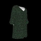 Right side of green patterned blouse on a black background
