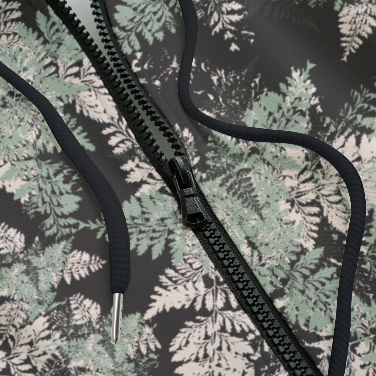Front detail of hoodie with floral pattern on a black background