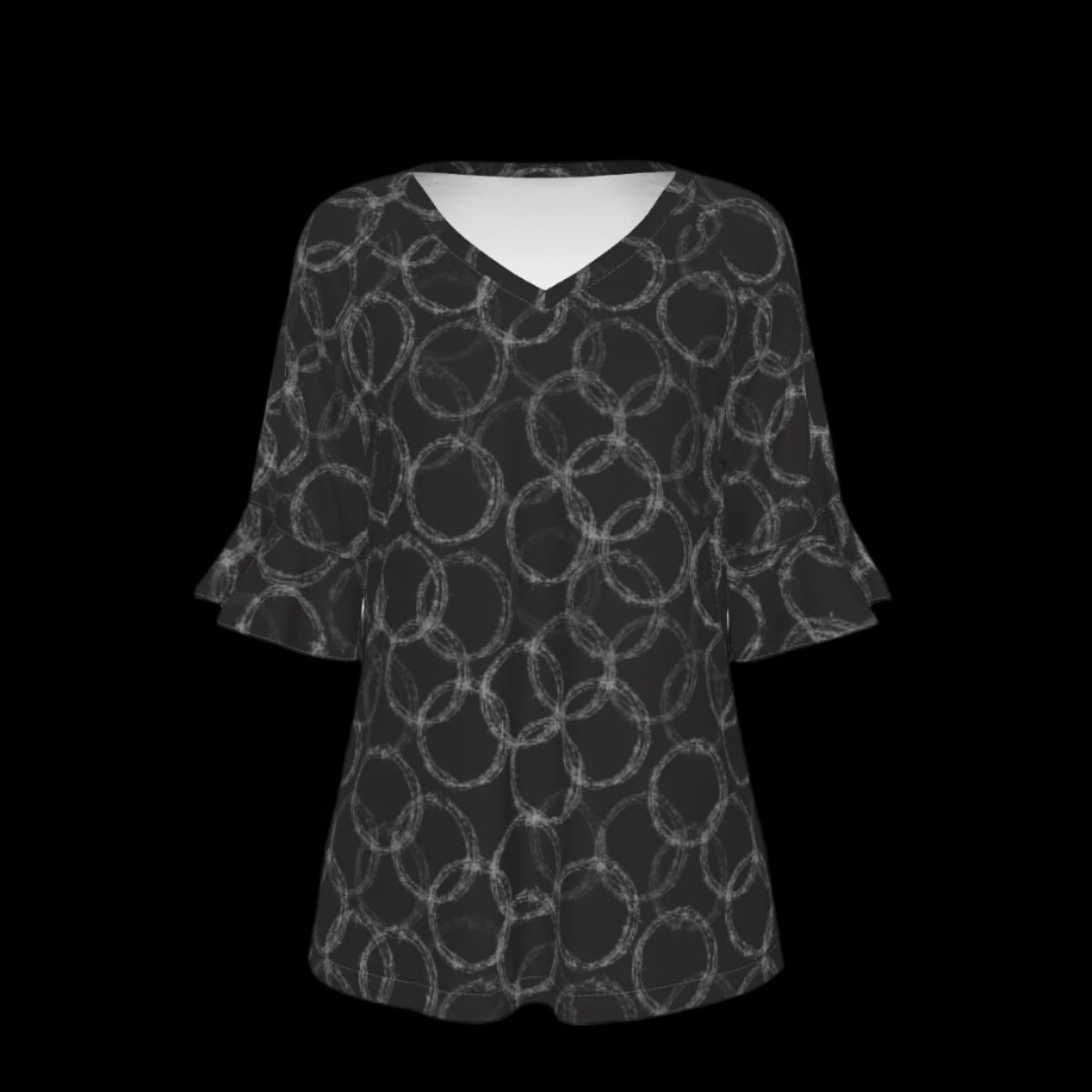Front of black and white patterned blouse on a black background