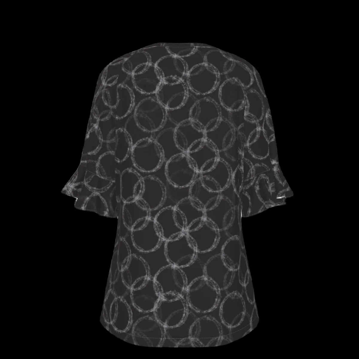 Back of black and white patterned blouse on a black background