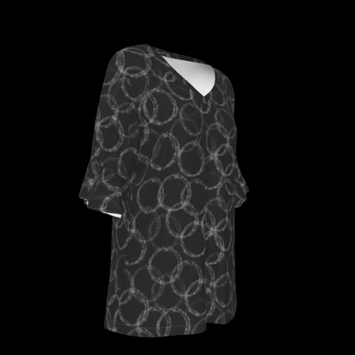 Right side of black and white patterned blouse on a black background